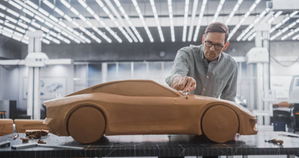 istock Creative Automotive Designer Working on a Prototype Car Out of Polymer Modeling Clay. Focused Professional Modeler Contemplating the 3D Sculpture, Looking Thoughtfully at the Model 1516861714