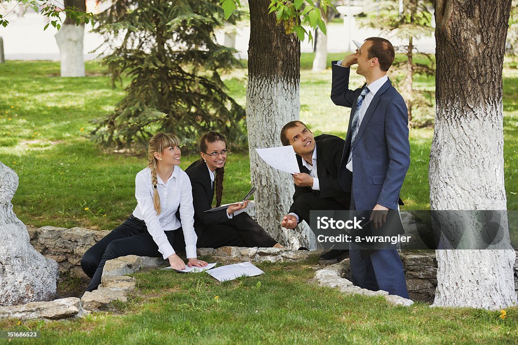 Young business people in a city park other photos of "Business people" series: Adult Stock Photo