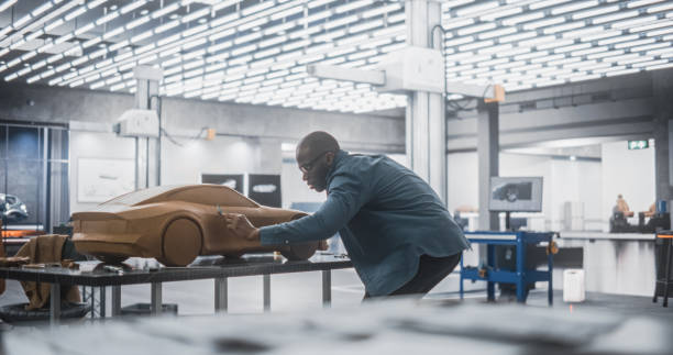 istock African Automotive Designer Using a Spatula to Create a Prototype Car Out of Polymer Modeling Clay. Focused Black Modeler Working in a Research and Development Studio at a Vehicle Production Factory 1516874549