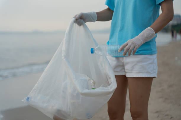 istock Save water. Volunteer pick up trash garbage at the beach and plastic bottles are difficult decompose prevent harm aquatic life. Earth, Environment, Greening planet, reduce global warming, Save world 1516877364