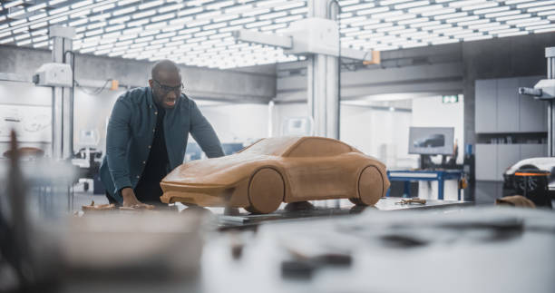 istock African Automotive Designer Using a Spatula to Create a Prototype Car Out of Polymer Modeling Clay. Focused Black Modeler Working in a Research and Development Studio at a Vehicle Production Factory 1516878526