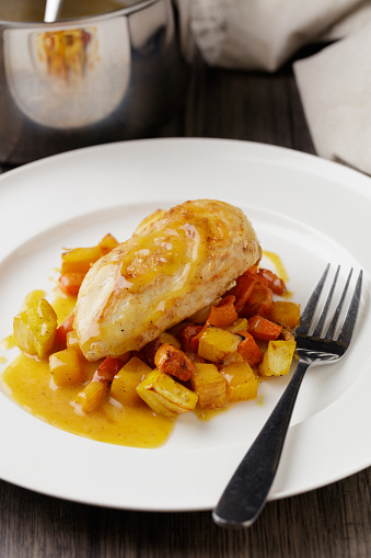 close view of homemade pan-fried chicken breast with winter ratatouille and miso beurre Blanc