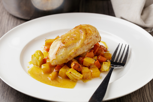 close view of homemade pan-fried chicken breast with winter ratatouille and miso beurre Blanc