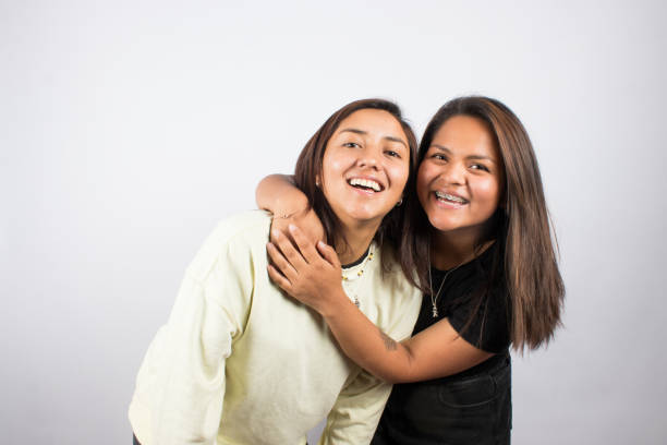 istock two young women embracing on a white studio background 1516898366