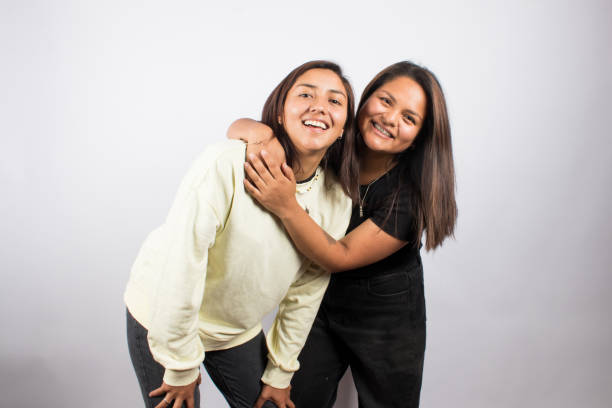 istock two young women embracing on a white studio background 1516898374