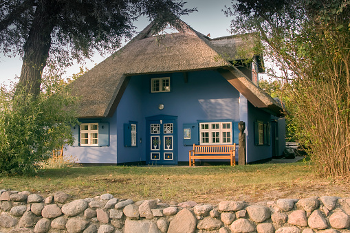 Olsztynek, Poland - August 31,2019: Old rural log house with herbal pump room, Warmian-Masurian Voivodeship, Poland
