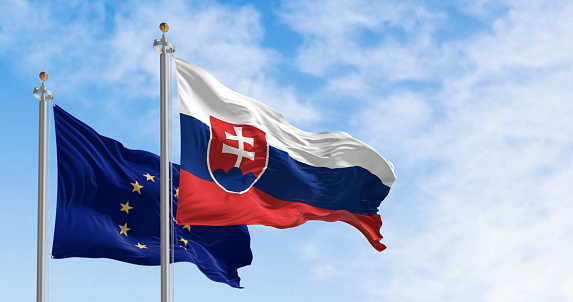 Slovakia and the European Union flags waving in the wind on a clear day. Slovakia is a member of the European Union and the Eurozone. 3d illustration render. Fluttering fabric