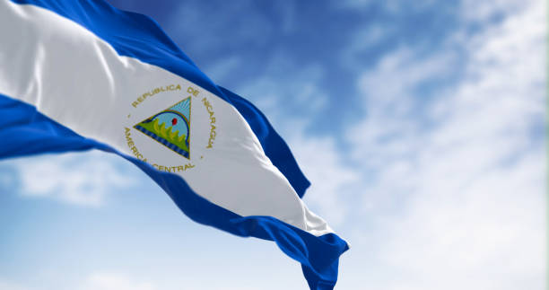 Nicaragua national flag waving on a clear day Nicaragua national flag waving on a clear day. Blue, white, and blue with a national coat of arms. 3d illustration render. Fluttering fabric. Selective focus flag of nicaragua stock pictures, royalty-free photos & images