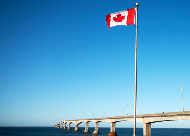 istock Canada Flag in front of Confederation Bridge. 1516909601
