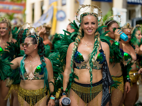 Cruz Bay, St John/US Virgin Islands-July 04, 2023: Fourth of July Carnival celebration in Cruz Bay, Costumed group of women parading and dancing in the street in Cruz Bay.