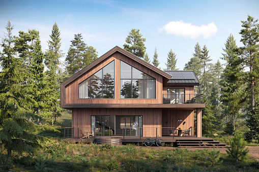 3d rendering of wooden forest house surrounded by trees. Digitally generated image of a luxurious forest bungalow with large windows during day.