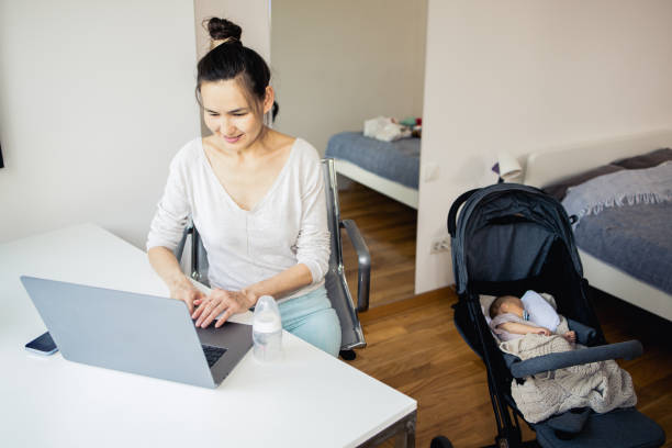 istock Woman with a small baby is working from home 1516948086