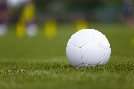 A Soccer Ball on the Lush Green Grass of the Soccer Pitch, Anticipating the Next Game. Soccer Football Classic Ball on Turf Field