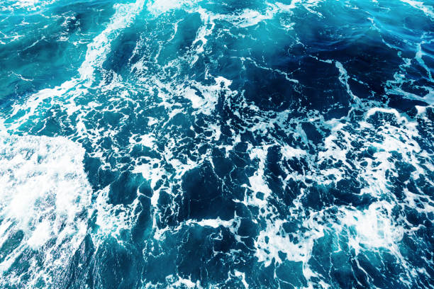 istock Ocean water background with foam. Ocean water splash. Not a calm 1516987625