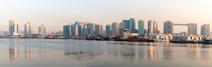 Skyline view of Dubai Creek reflection in Dubai canal.