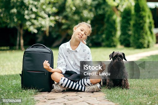 istock Happy kid in going to school for the first time. Child girl with bag go to elementary school. Child of primary school. Pupil go study with backpack. Back to school 1517004388