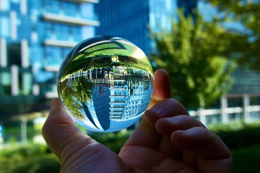 Crystal ball against modern buildings