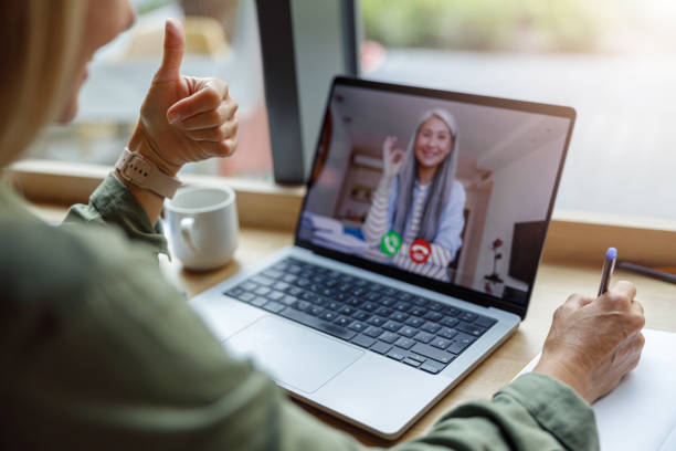 Close up of woman freelancer have video conference with client and making notes sitting near window Close up of business woman have video conference with client and making notes sitting in cafe online tutors stock pictures, royalty-free photos & images