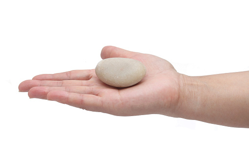 Hand holding a Pebble, isolated on white