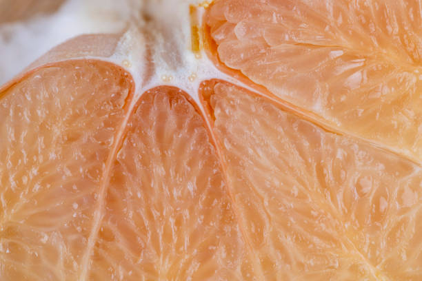 istock Freshly peeled pink pomelo on the table 1517071664