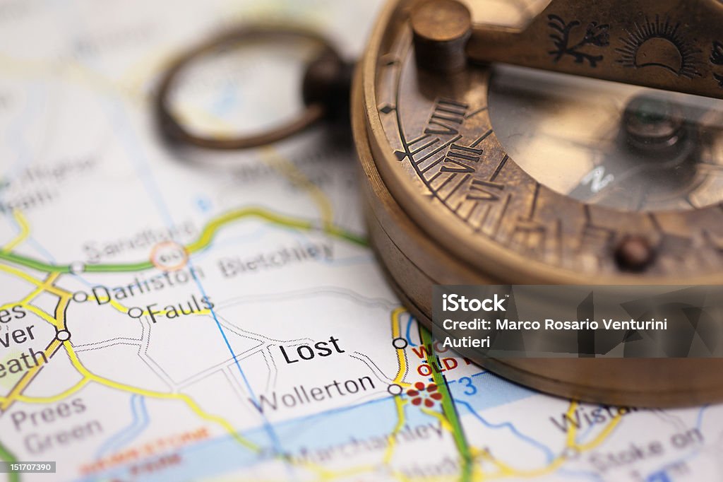 Lost on the map - Travel concept with compass "Lost" on a faked map of England, with an old-style magnetic compass. Focus on "Lost" and some parts of the compass. AdobeRGB Arranging Stock Photo