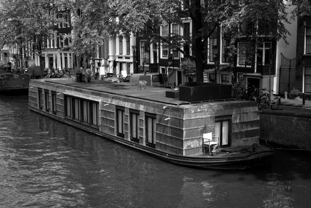 A boat mored in a canal in a city