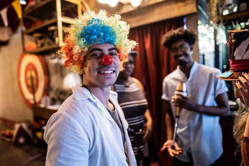 Funny clown juggling many balls