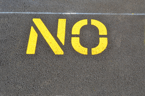 No Parking sign on asphalt lot