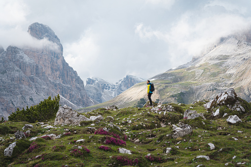 Caucasian man, admiring view of Dolomites, during his hike