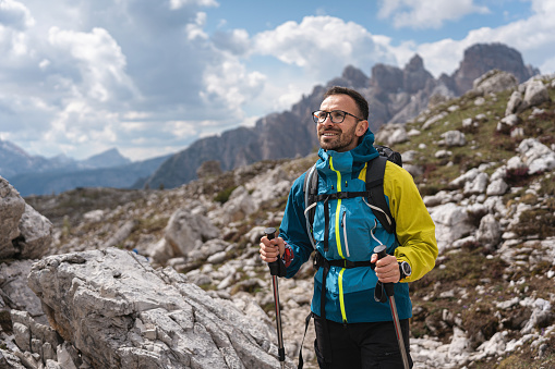 Caucasian man, hiking through the Dolomites while admiring the view of nature on Tre Cime di Lavaredo