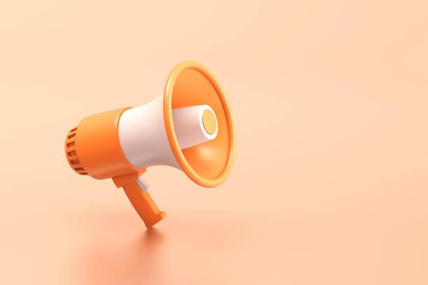 istock Single orange and white electric megaphone with a handle stands on a orange background 1517185045