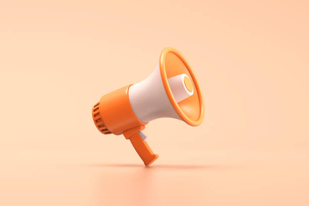 istock Single orange and white electric megaphone with a handle stands on a orange background 1517185594
