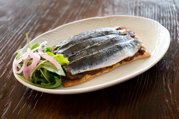 Studio photo of a plate of sardines on toast with salad, gourmet style Studio photo of a plate of sardines on toast with salad, gourmet style. Spanish cuisine concept deli pie stock pictures, royalty-free photos & images