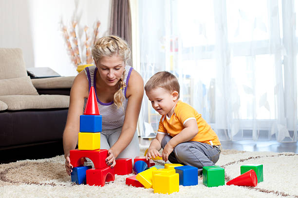 istock Mother and small boy playing blocks together indoors 151723954
