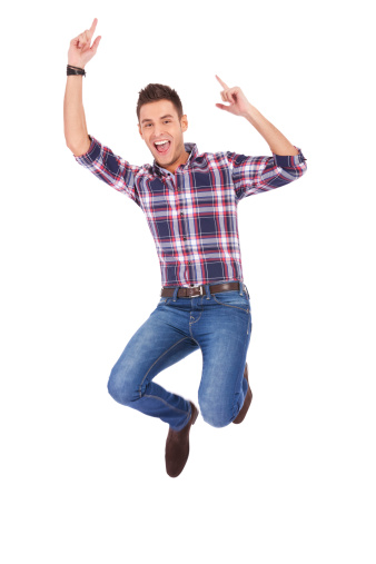Handsome man jumping for the joy of victory on white background