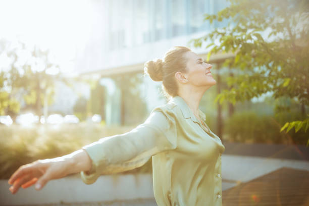 istock happy modern female worker near office building rejoicing 1517256192