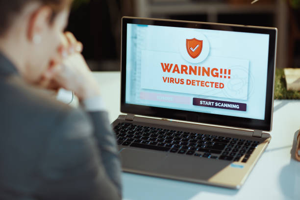 istock Seen from behind modern woman discovered computer virus 1517273591