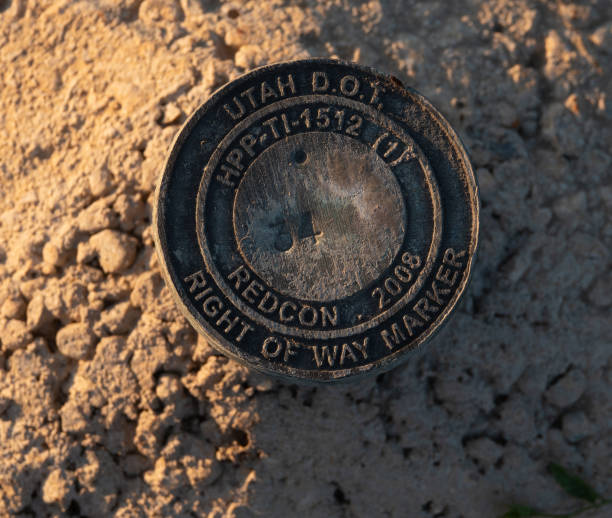 istock Brass cap right of way marker in concrete. 1517285601