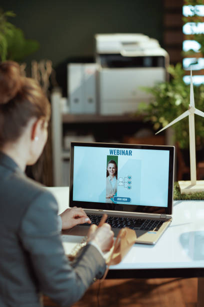 istock modern woman writes in notebook and having online webinar 1517286692