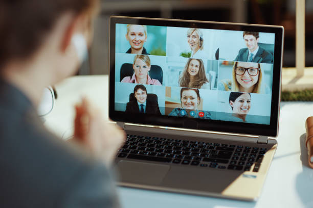 istock Seen from behind modern woman with laptop video chatting 1517300035