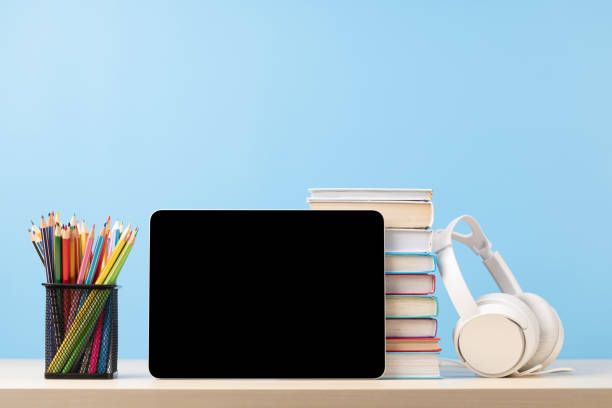 istock Tablet with colorful pencils and stack of books 1517342611