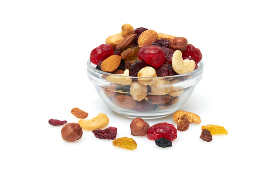 Set of nuts and dried fruits in a bowl. Hazelnut, cashew, almonds, raisin, cranberry, cherry, isolated on a white background.