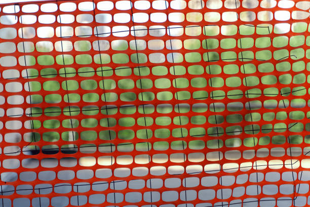 istock Red plastic safety net on green background 1517368034