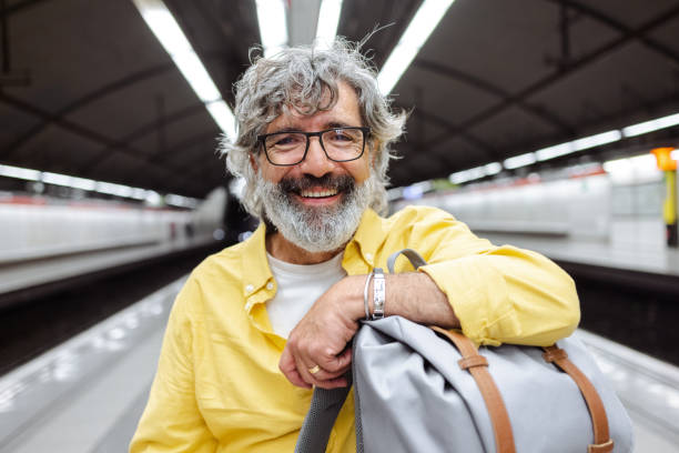 istock Senior man using smart phone in subway 1517368589