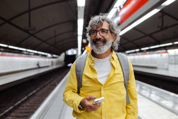 istock Senior man waiting for a train and using smart phone 1517372396