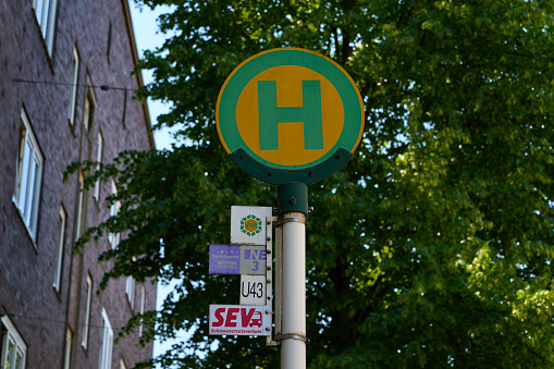 Dortmund, Germany - 06.04.2023: Road sign with an H. A stop for buses and trams. Public transport in a city.