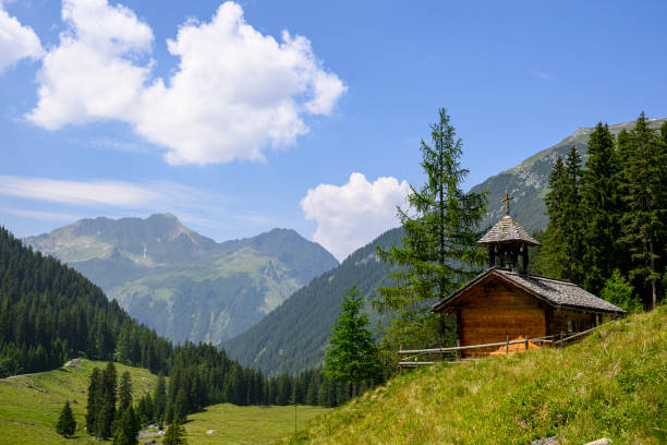 Landscape in the mountains with an old wooden chapel Landscape in the mountains with an old wooden chapel. Silbertal, Montafon, Vorarlberg silbertal stock pictures, royalty-free photos & images