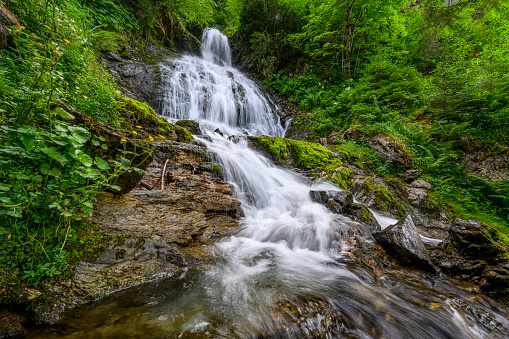 Beautiful waterfall in the mountains of the Alps. Silbertal, Montafon, Vorarlberg