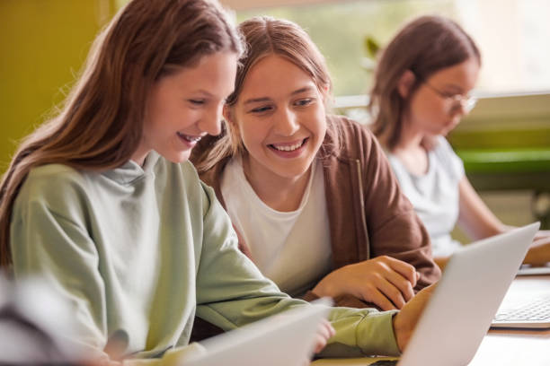 istock Teenage girls using laptops in the classroom 1517462926