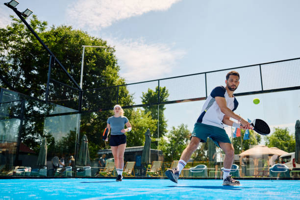 istock Young athlete hitting a ball during paddle tennis match. 1517473166